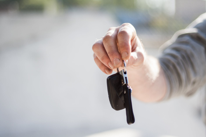 a person giving a car key